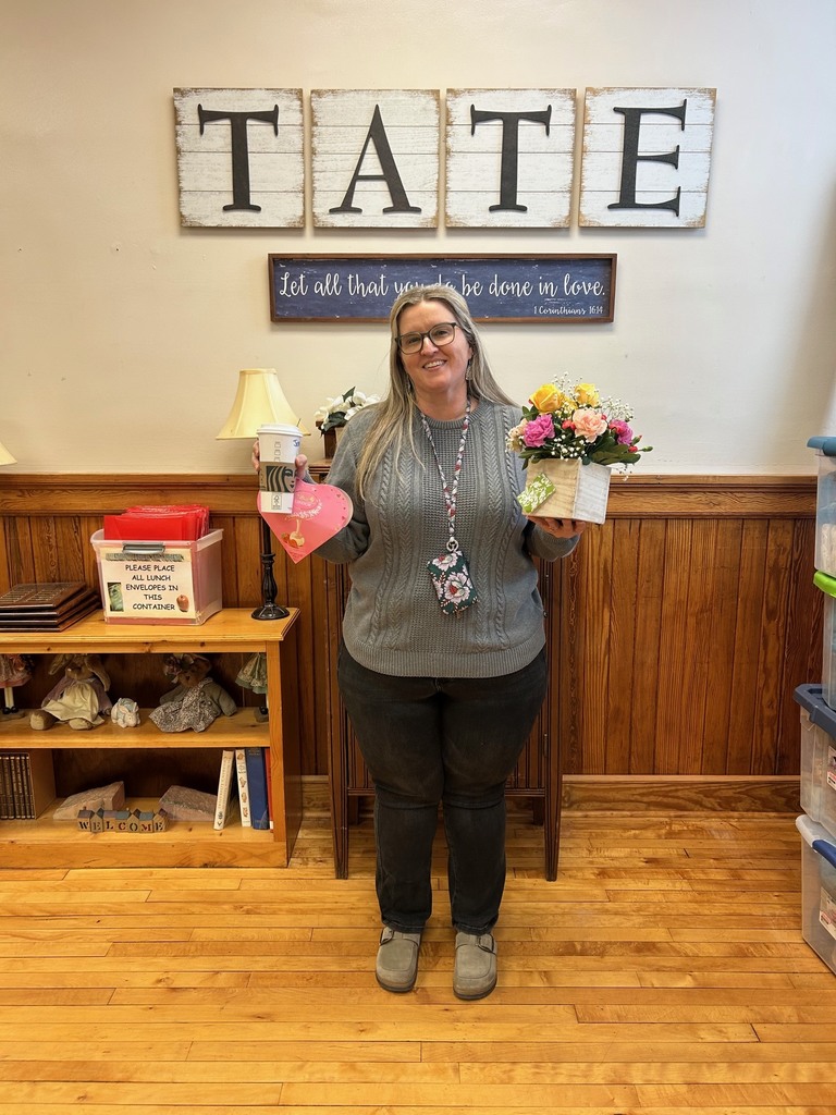 Woman holding, flowers, candy, and a starbucks drink
