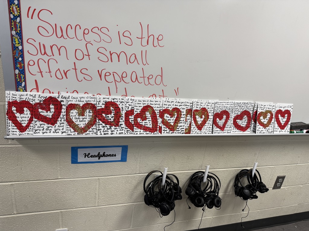 Cursive writing valentines displayed on whiteboard.