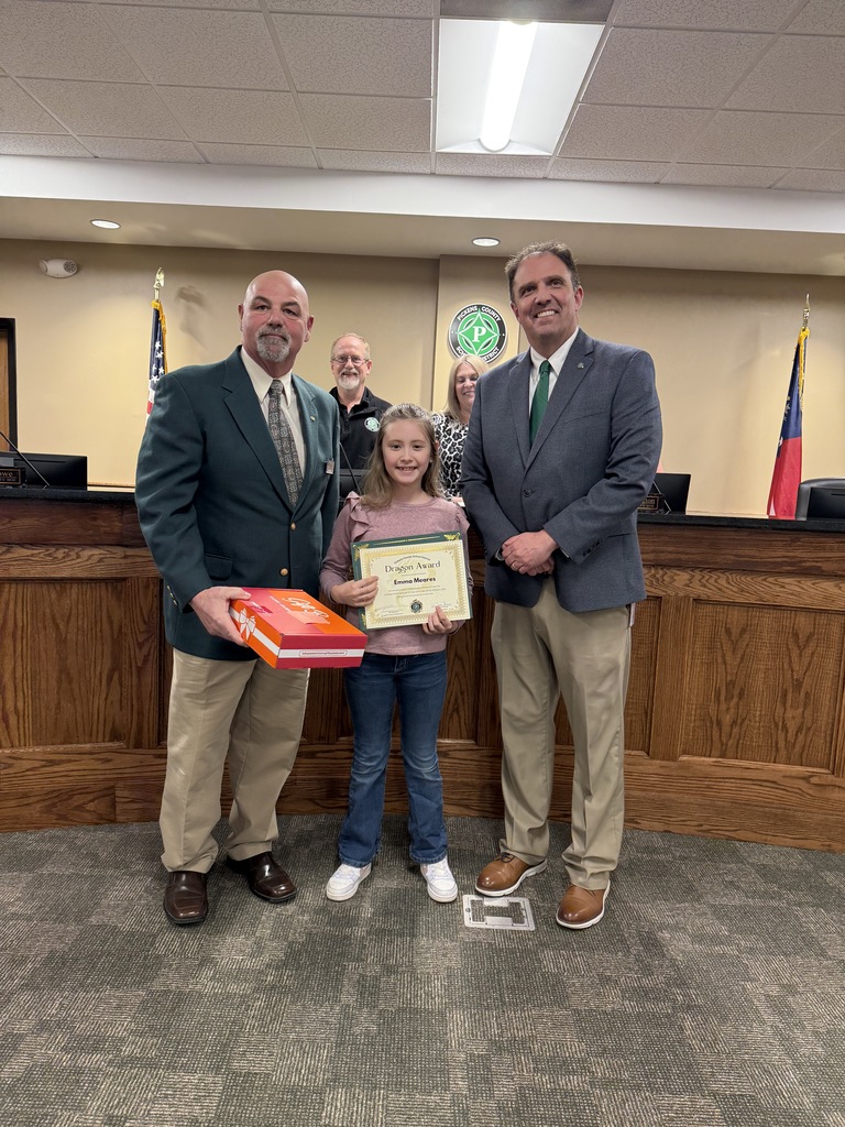 Emma receives the Dragon Award at the February Board of Education meeting.
