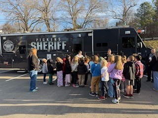 Students standing in line to walk through the Sheriffs office command trailer