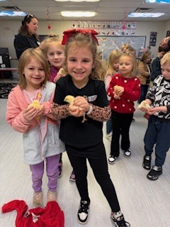 Two students holding yellow baby chicks