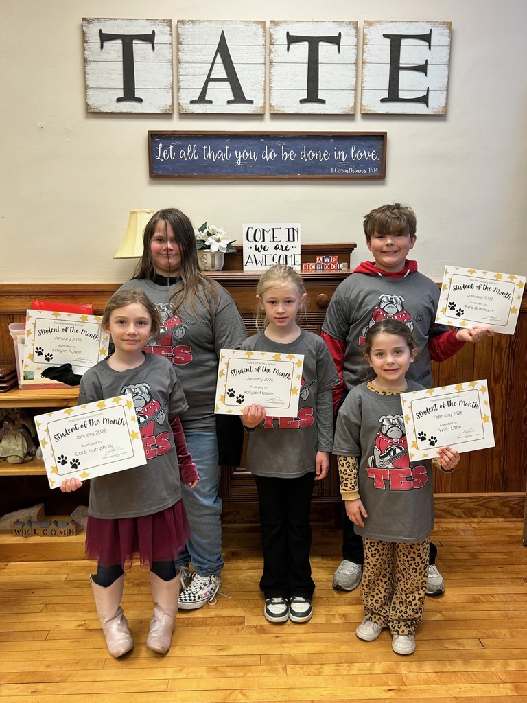5 students in matching shirts holding certificates