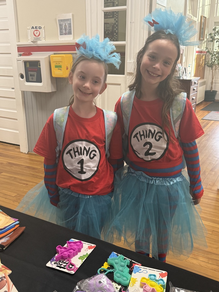 Two girls in blue tootoos, and red shirts as thing 1 and thing 2