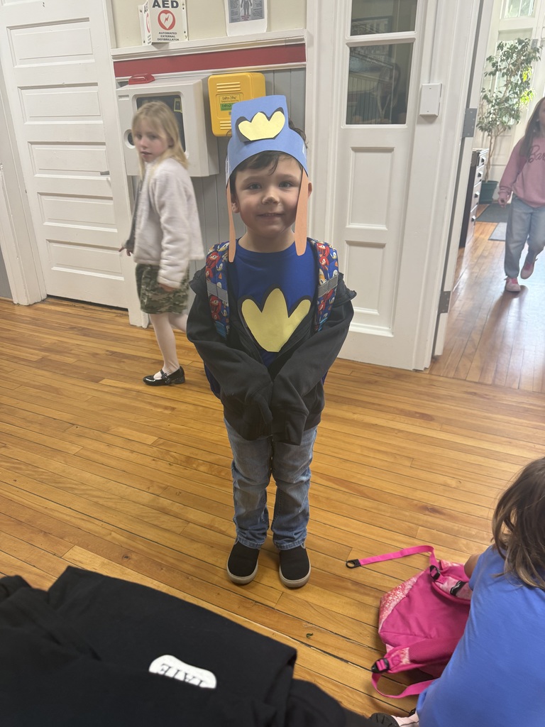Child dressed up in a blue shirt and a yellow duck foot