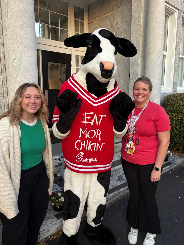 Chick Fil a cow standing with two women