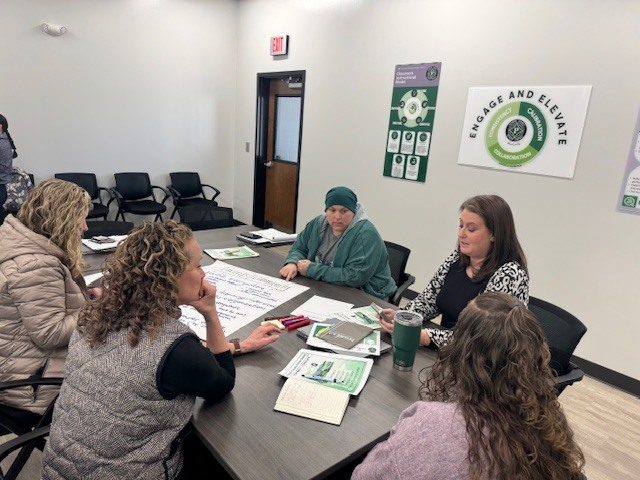 People gathered around tables for Superintendents Student Achievement and Success Team. 