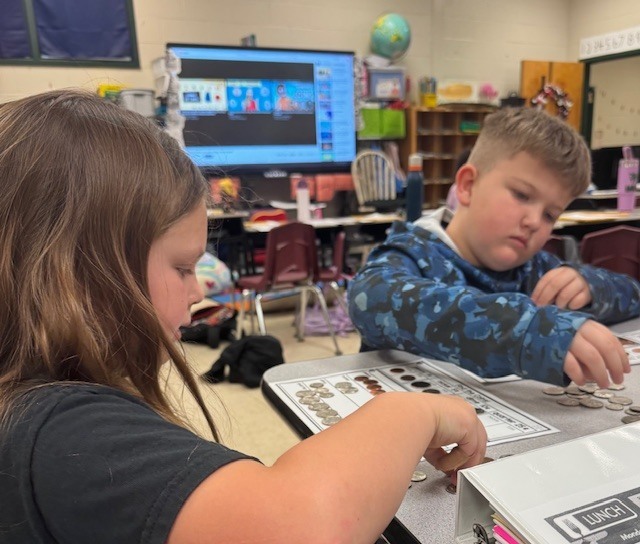Counting and sorting money in Ms. Sultan's first grade math classes.