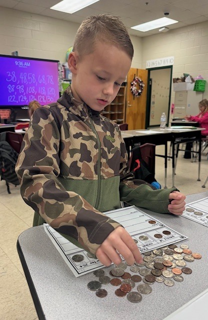 Counting and sorting money in Ms. Sultan's first grade math classes.