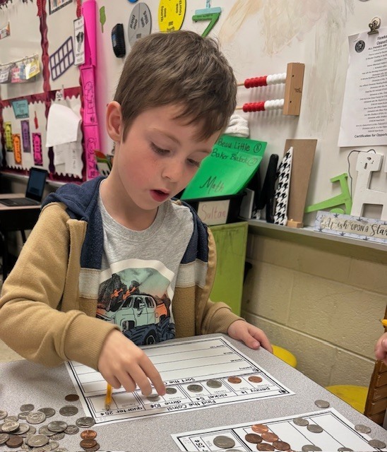 Counting and sorting money in Ms. Sultan's first grade math classes.