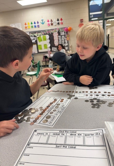 Counting and sorting money in Ms. Sultan's first grade math classes.