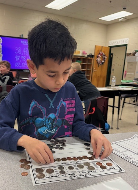 Counting and sorting money in Ms. Sultan's first grade math classes.