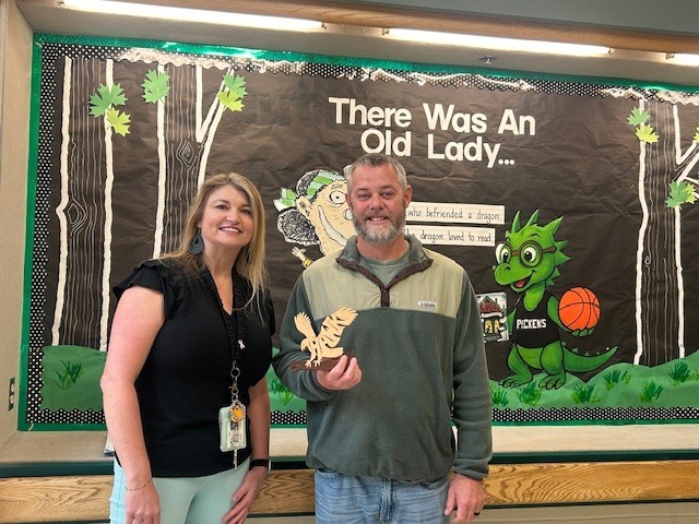 Ms. Jamie passes the Hawk to Coach Black! Congratulations, Coach!