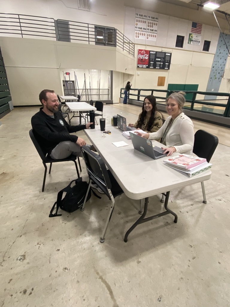 Coach Shostak and counselors Lexi Bowen and Summer Johnson seated at a rable enjoying breakfast