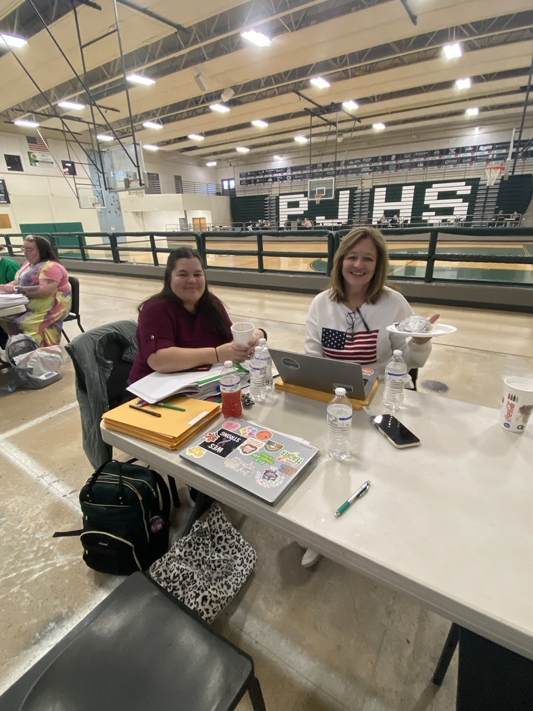 Teachers Jessica Long and Kim Pack seated at a table