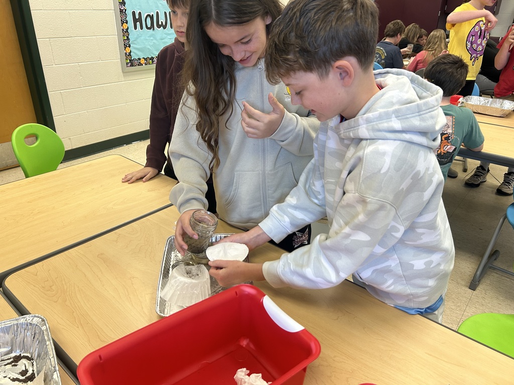 Fourth-graders testing materials and designing a water filter in STEM Lab.