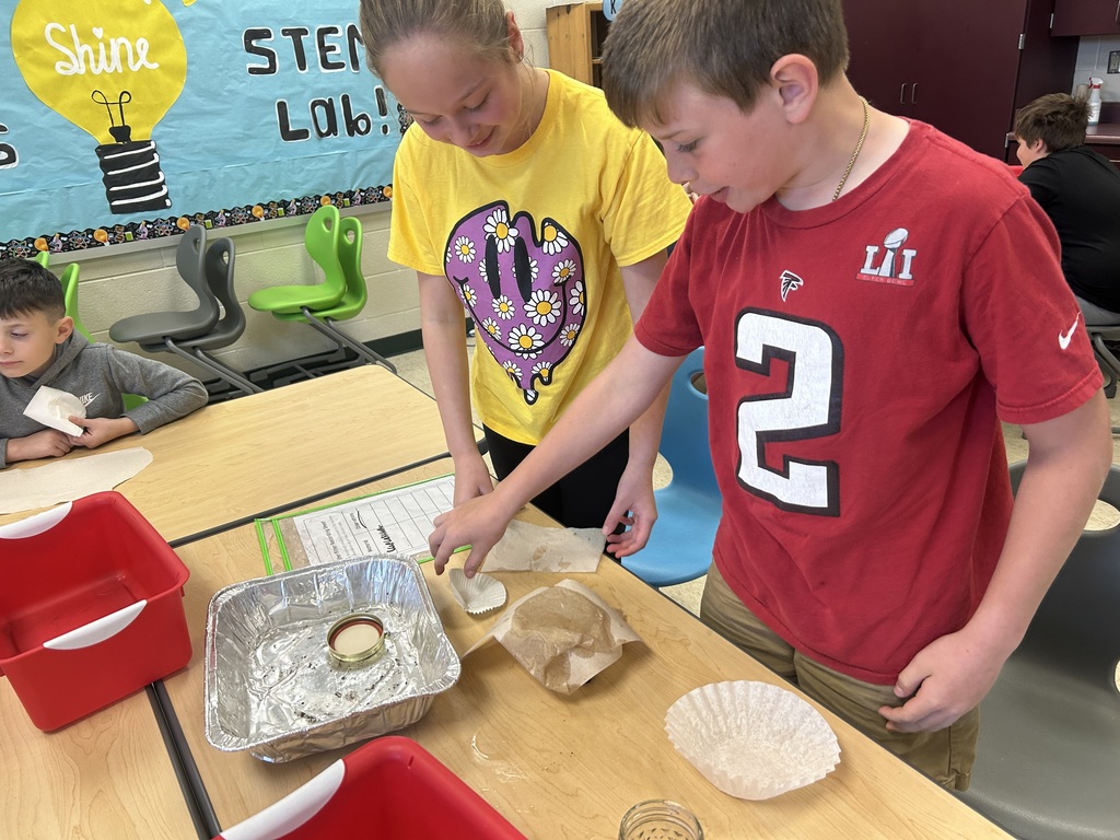 Fourth-graders testing materials and designing a water filter in STEM Lab.