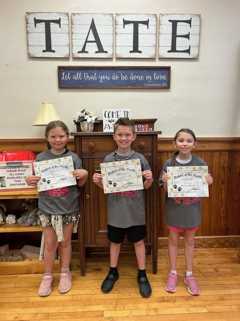 three students standing holding certificates 