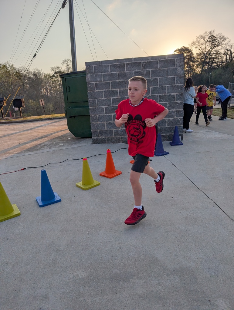Child running inside colorful cones