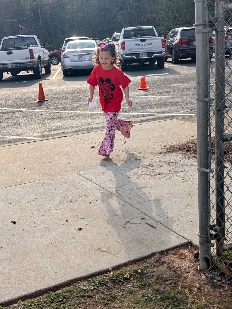 Female student running inside colorful cones