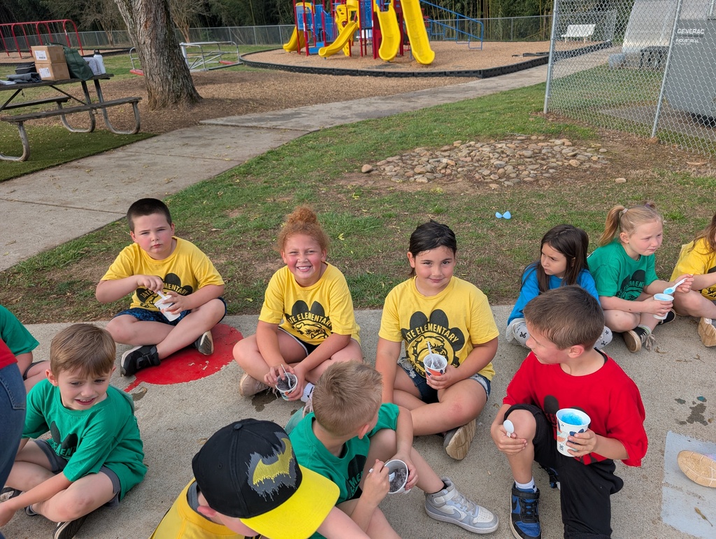 group of students sitting on the ground