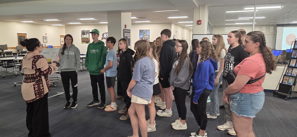 Group of students indoors listening to tour guide