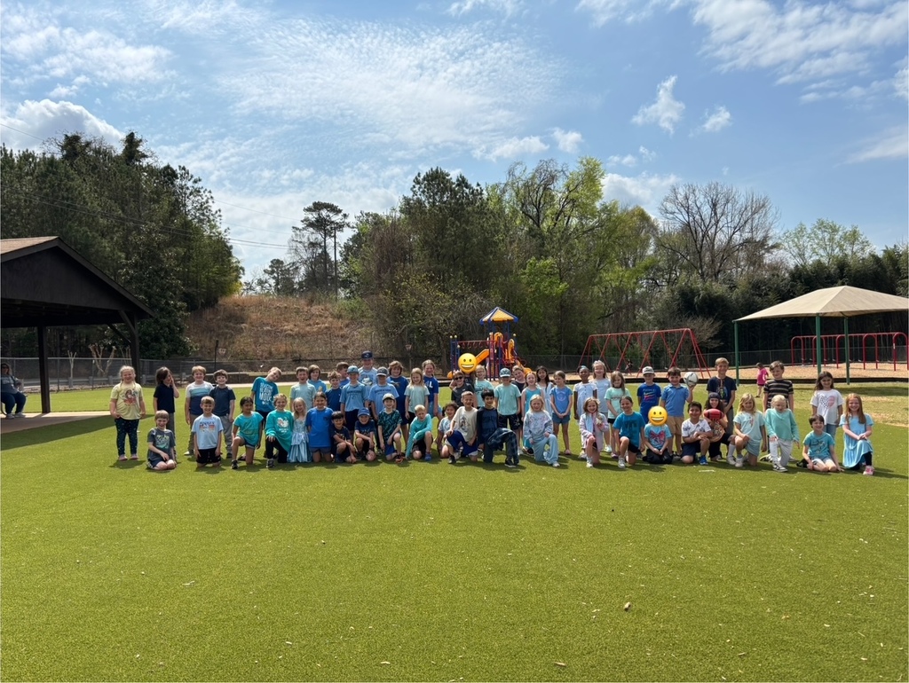 Group of kids standing on the playground wearing blue