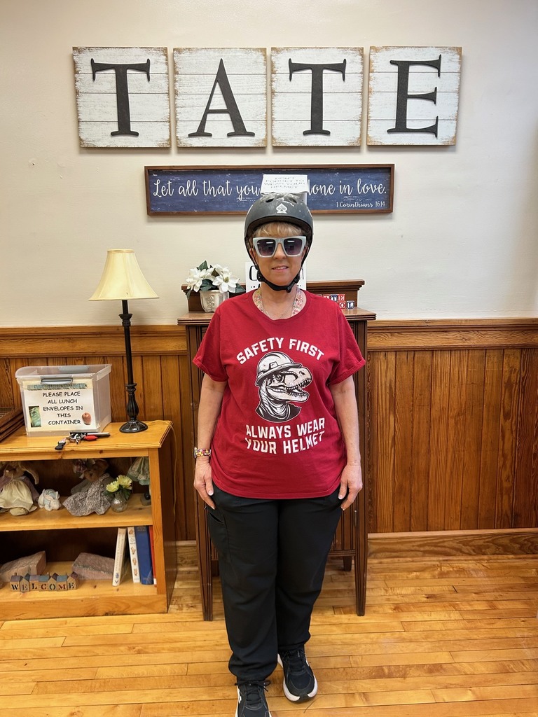 Woman dressed up in a helment, red shirt, and sunglasses