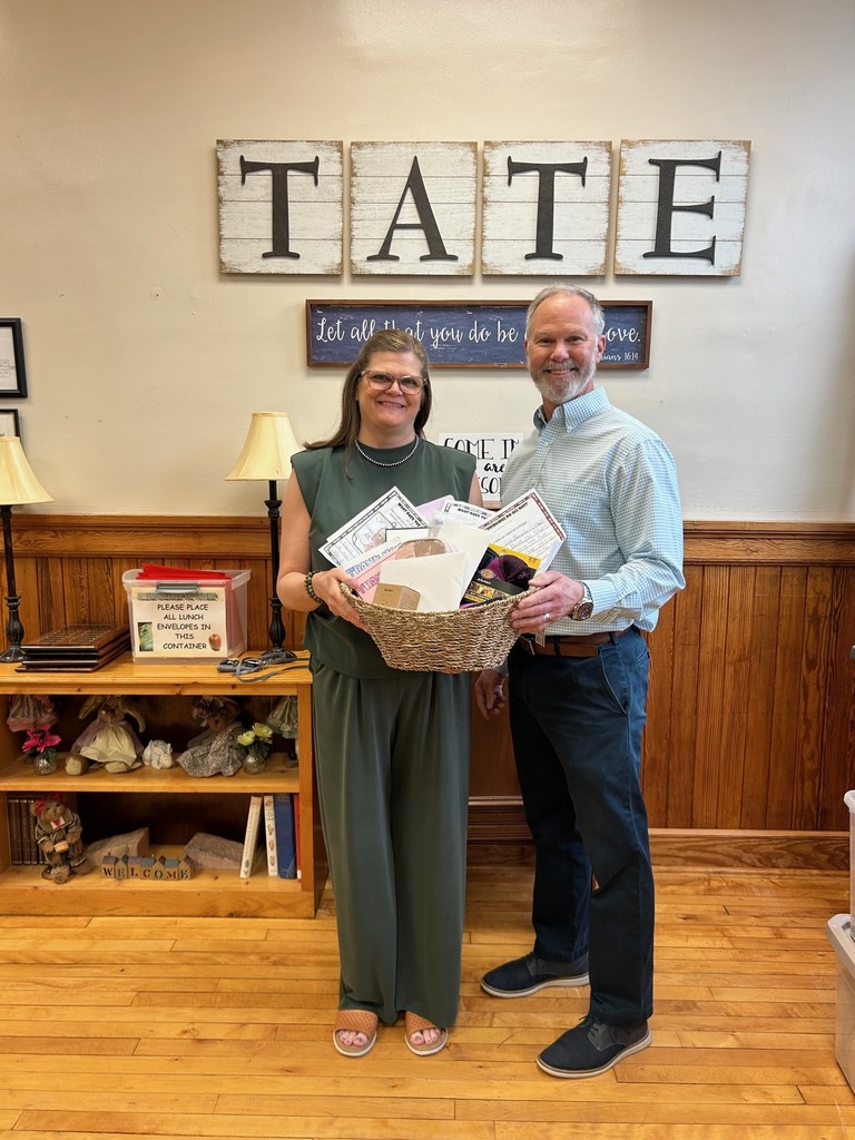 Man and woman standing holding a basket