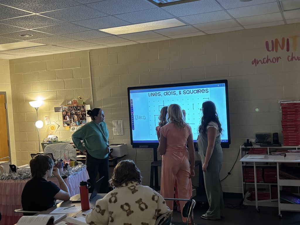 Students and Mrs. Sutton in front of Promethean Board