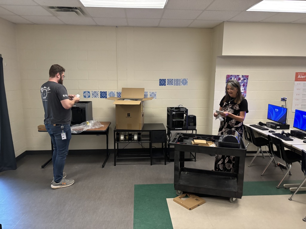 Ms. Perritt and someone from tech department setting up printers.