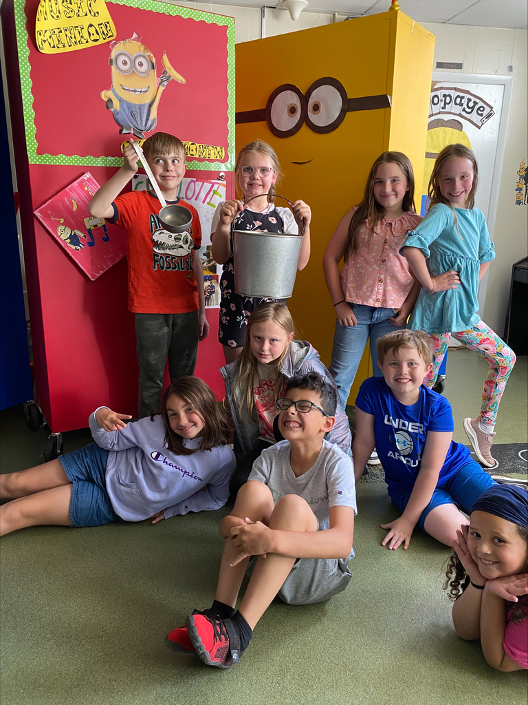 Group of kids a girl and a boy are holding a pail and a dipper