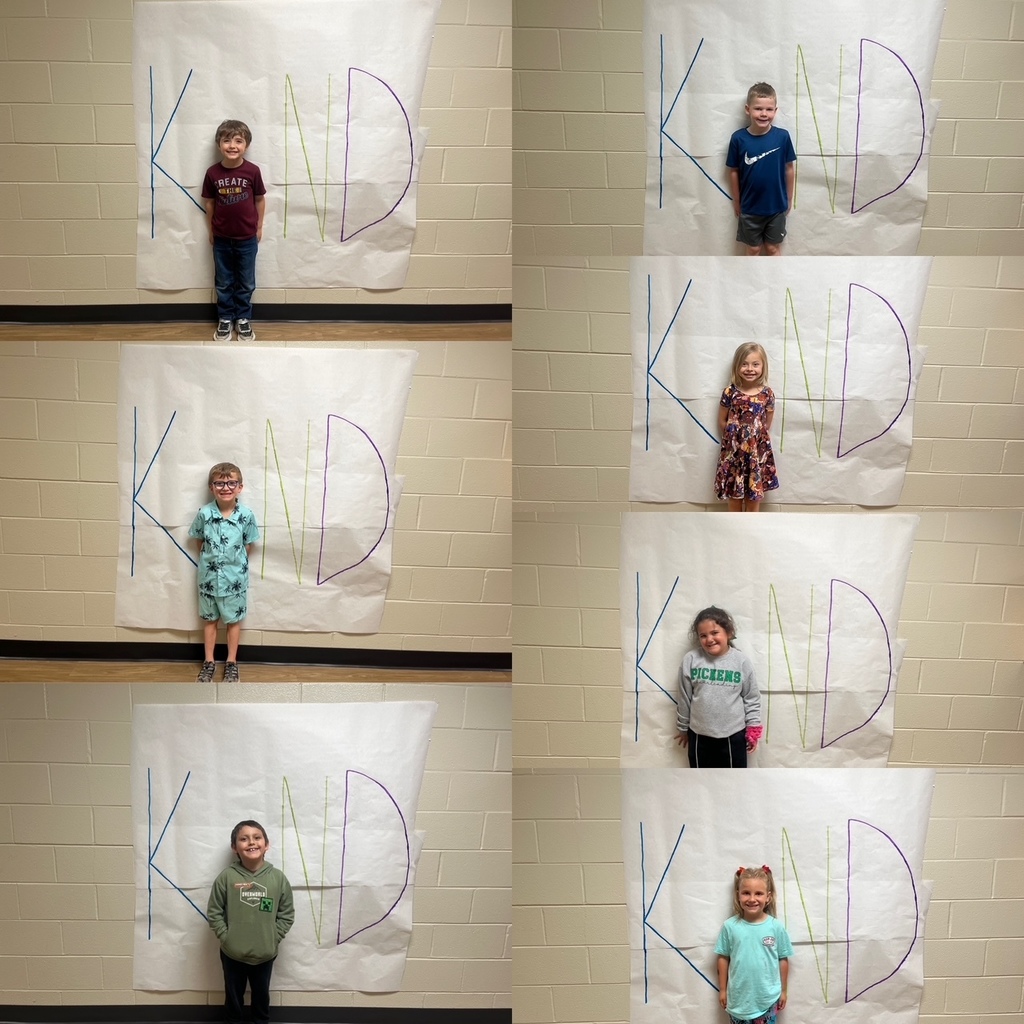 Kids standing in front of a poster with the letters  K N D. Their body is being used as the letter I