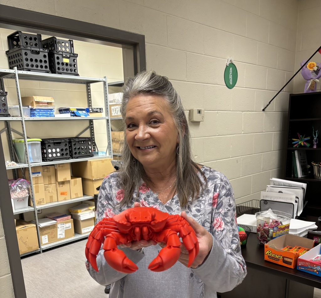 Ms. Perritt holding a red crab figurine