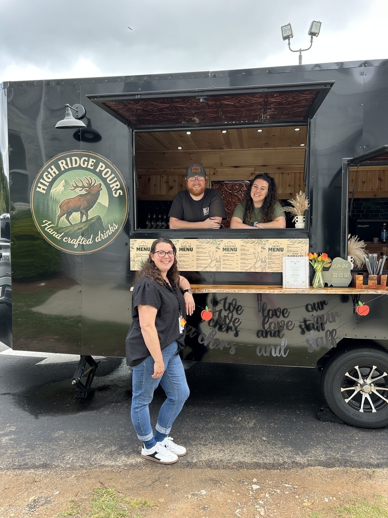 High Ridge Pours Hand Crafted Drinks trailer two people in the window and one person standing outside of the trailer