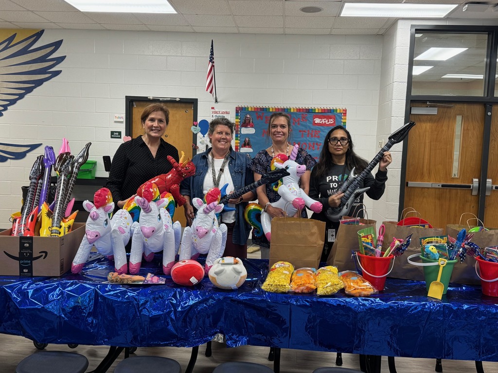 Teachers and staff giving out door prizes.