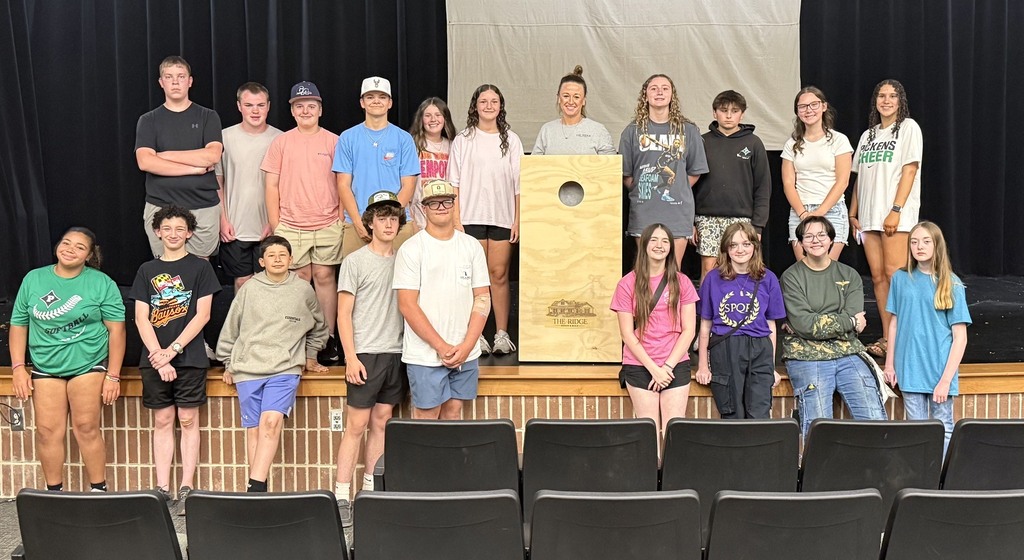 Students with a finished cornhole board