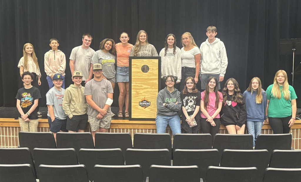 Students in picture with cornhole boards