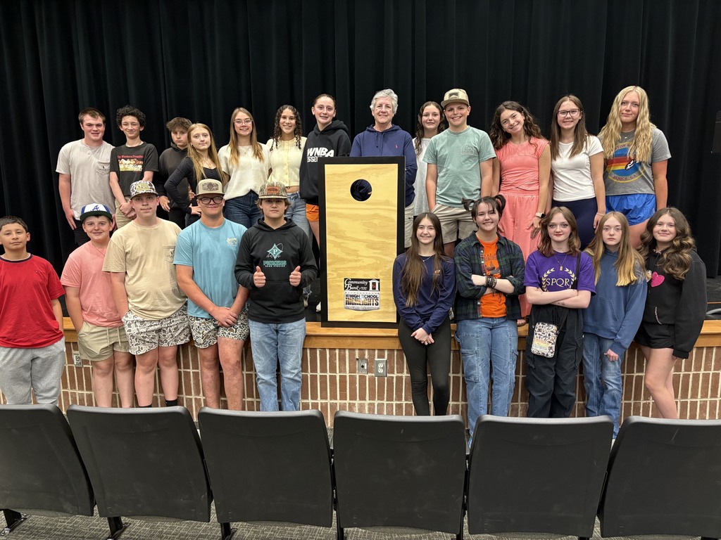 Students standing beside a project