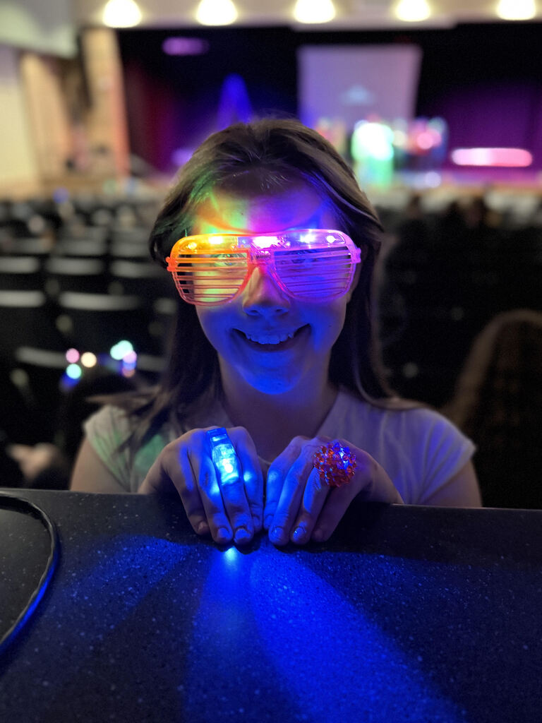 Student wearing glow glasses in the dark