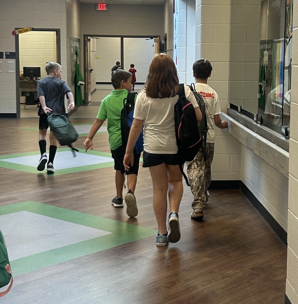Students choosing backpacks donated by Hallyboy Foundation.