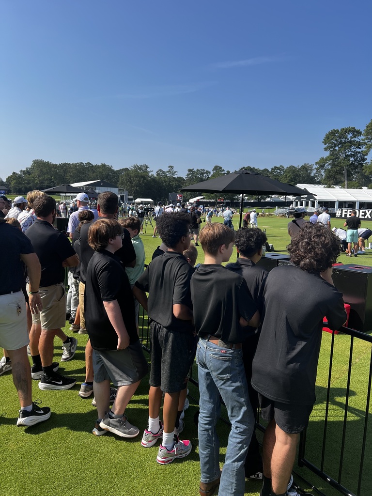 Students watching a golf event