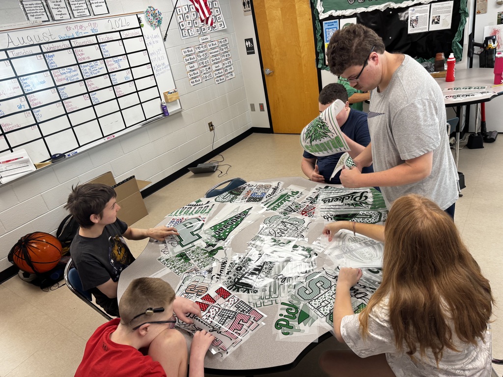 Group sorting through graphics at a table