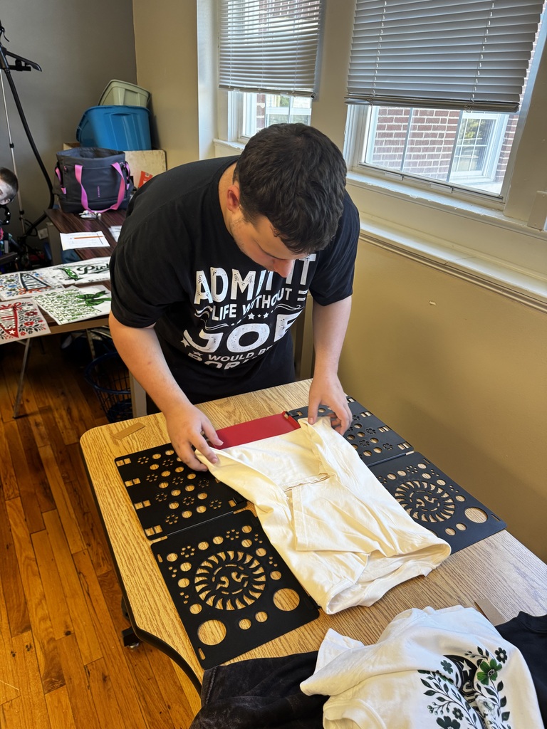young man applying the design to a t shirt