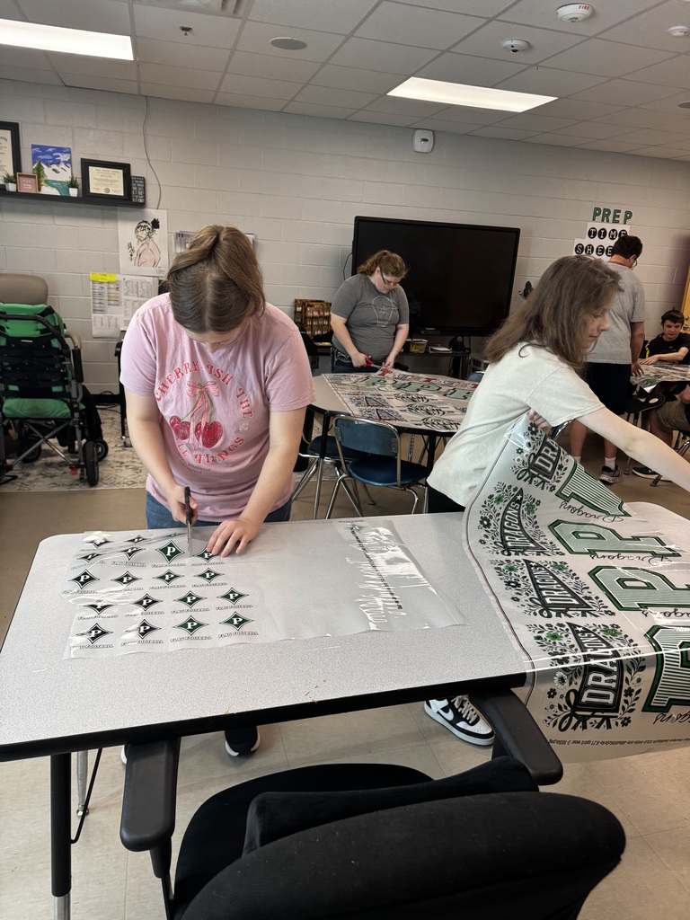 Girls cutting out graphics for shirts