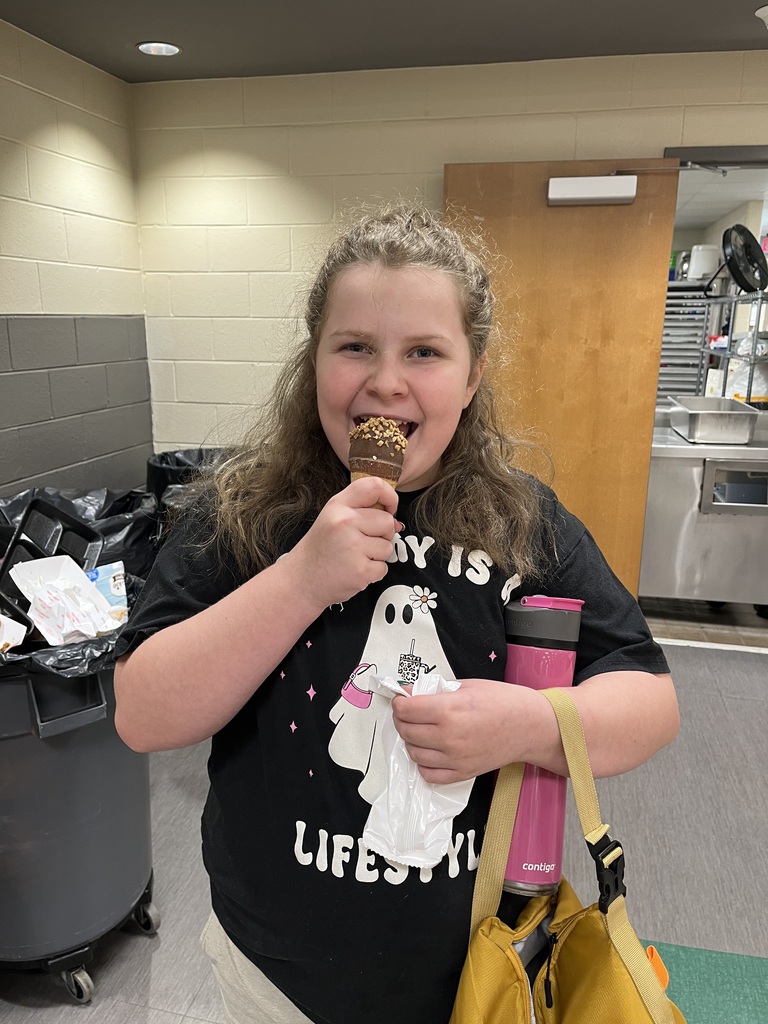 Girl posing with her ice cream cone at lunch