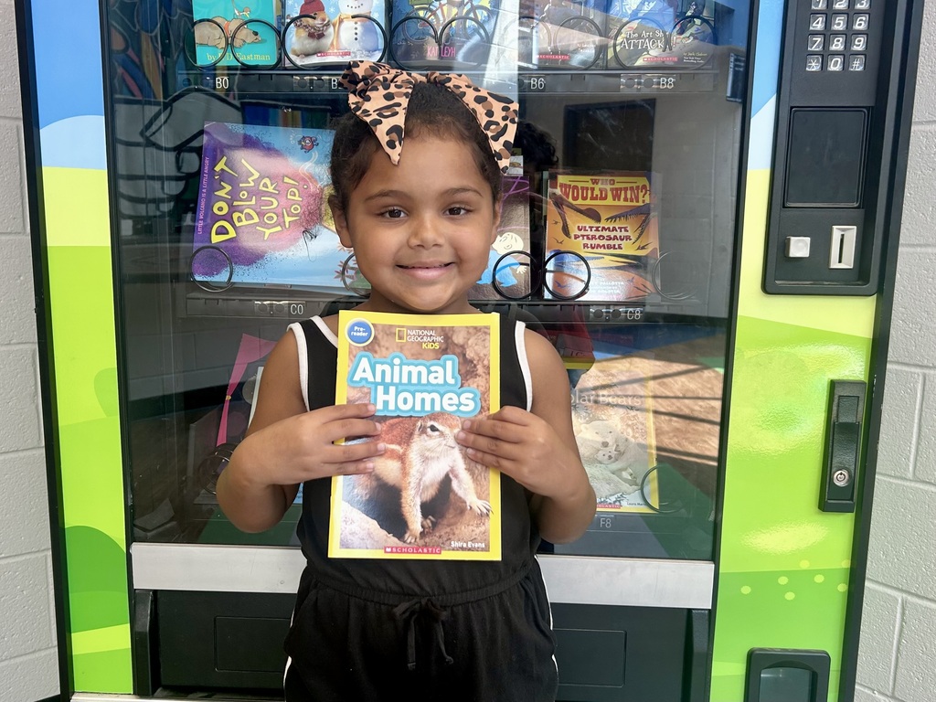 Spencer earned a trip to the Book Vending Machine for completing her fluency folder.