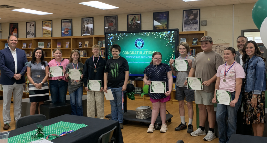 Students of the month with district leaders