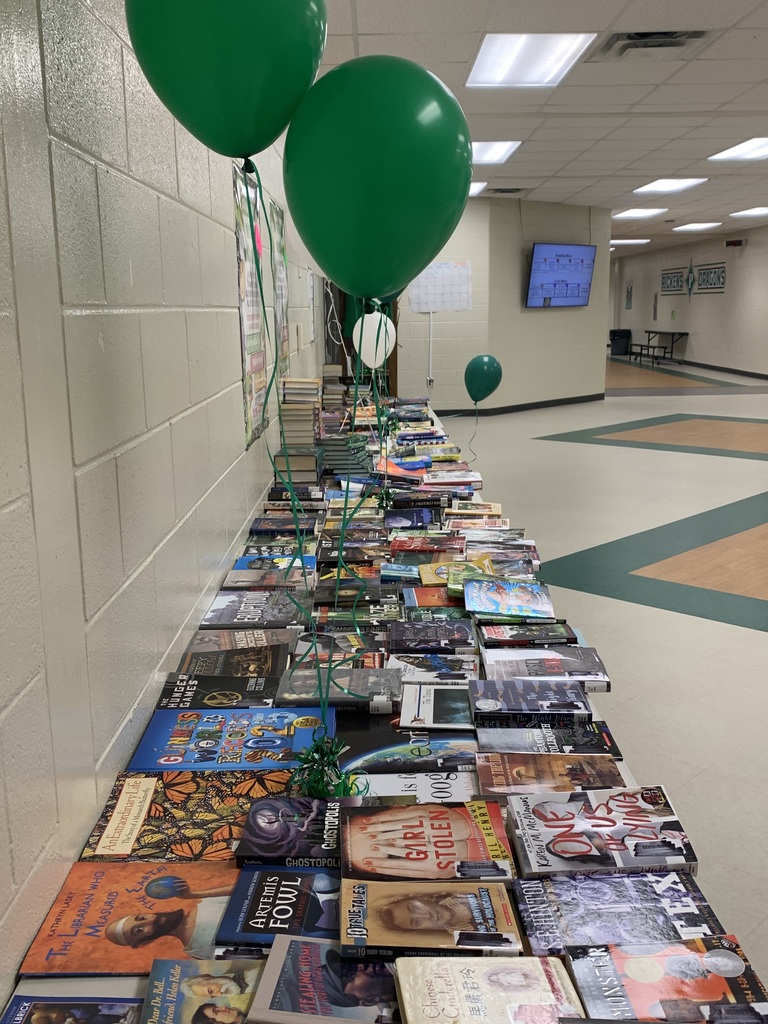 four long tables filled with books