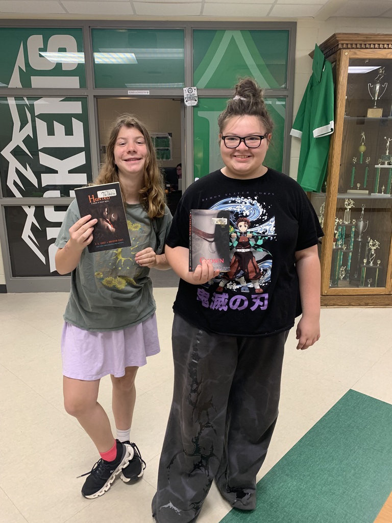 Girls with the books they chose from the book share table