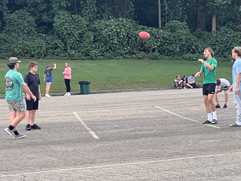 Students throwing a football outside